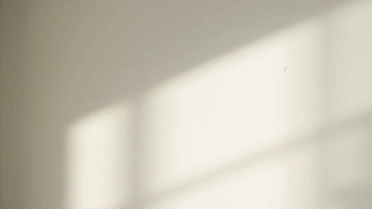 Parede clara de um cômodo vazio com sombras angulares de uma janela projetadas em diagonal pela luz do dia, sem texto, sem diagramas, sem rótulos