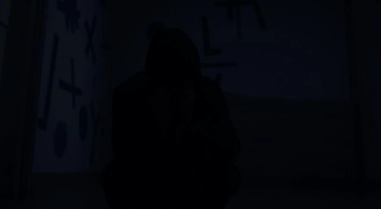 A dimly lit room, the walls adorned with abstract shapes and patterns, casting an uneasy, unsettling atmosphere. In the foreground, a figure sits hunched, their face obscured by their hands, an expression of anguish and vulnerability. Shadows creep in from the edges, enveloping the scene in a sense of isolation and dread. The lighting is soft and muted, creating a sense of weight and oppression. In the background, a blurred, indistinct landscape, hinting at the complexities and uncertainties that contribute to the causes of social anxiety. The overall composition conveys a sense of introspection, turmoil, and the internal struggles that manifest in this debilitating condition.