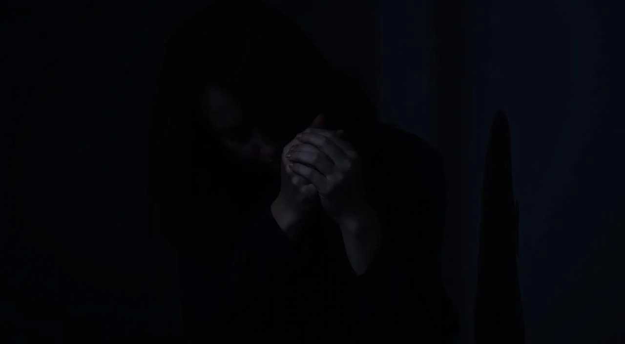 A dimly lit room, walls cast in shadows, a figure sits hunched, face obscured by hands. Tension and unease permeate the scene, a visual representation of social anxiety and shyness. Muted colors, soft lighting from a single source, create an introspective, isolating atmosphere. The subject's posture conveys a sense of vulnerability, a desire to withdraw from perceived judgment. Subtle details, like fidgeting fingers or a furrowed brow, hint at the internal turmoil and self-consciousness experienced. The composition emphasizes the individual's struggle, highlighting the distinction between timidity and social anxiety disorder.